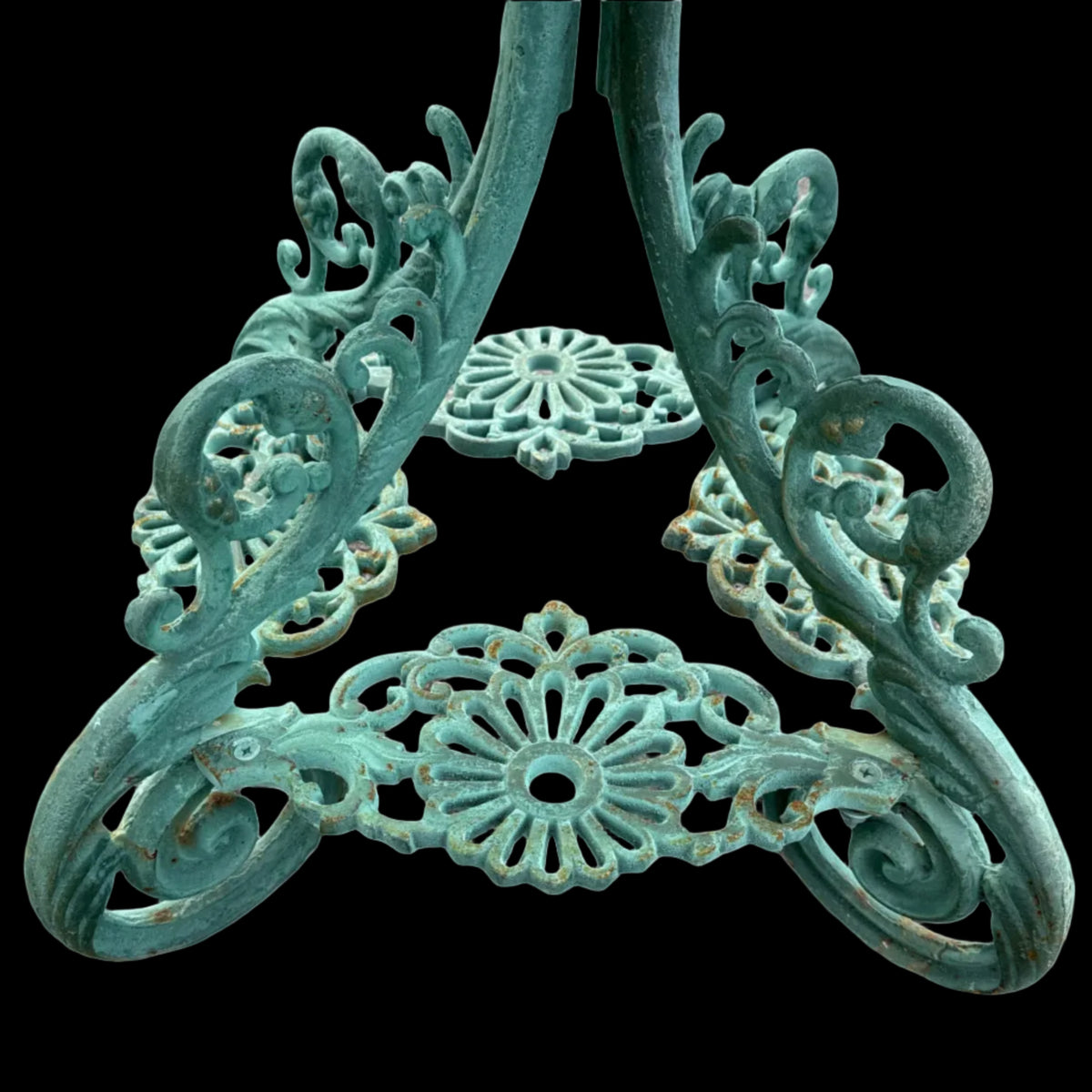 Decorative cast iron table legs with green rusted patina
