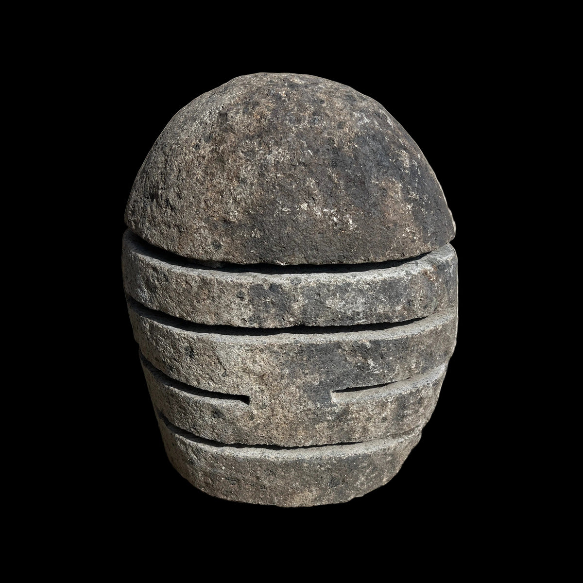 A spherical stone lamp with horizontal slits cut into it, intended for outdoor use.