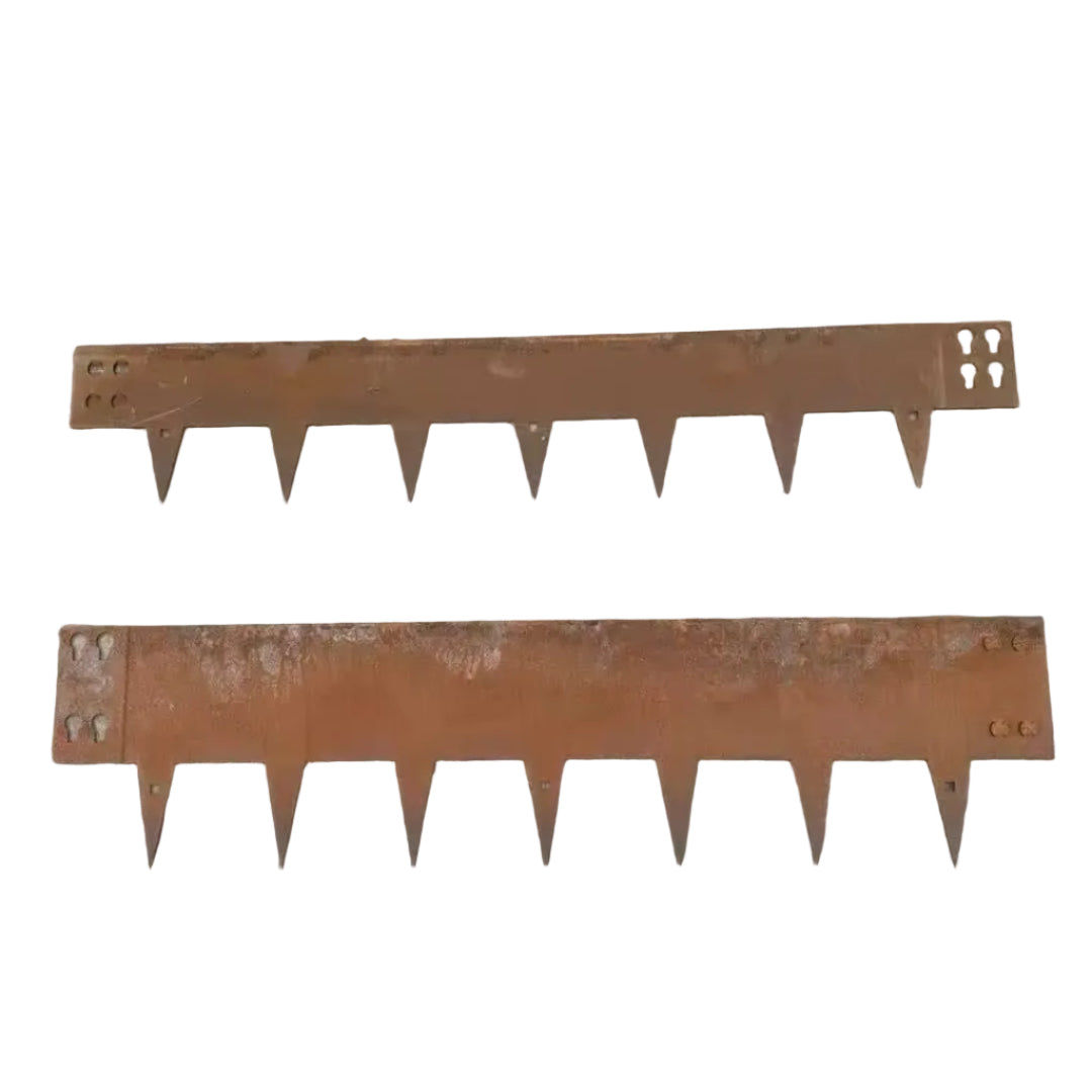 Two rusted metal tools with toothed edges on a concrete surface