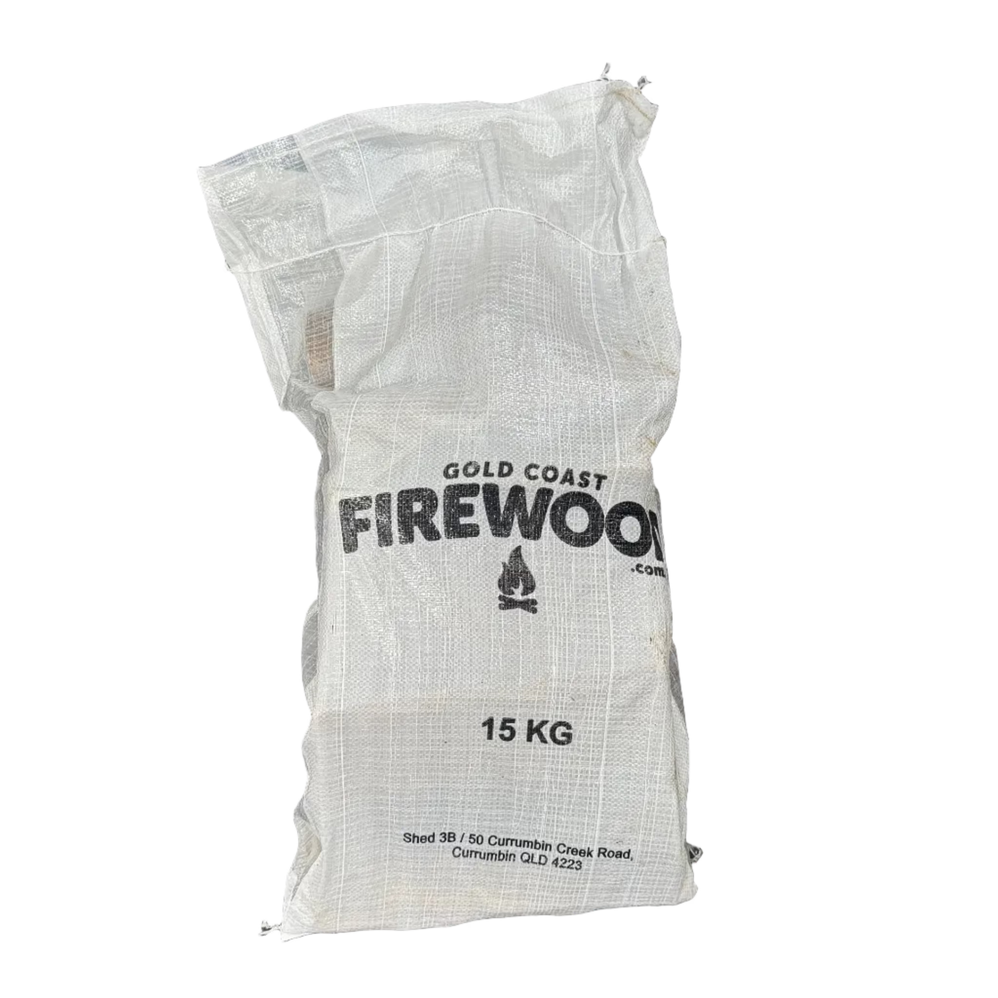 A 15 kg white woven mesh bag of Gold Coast Firewood, featuring black printed text and a small campfire logo, isolated on a white background.