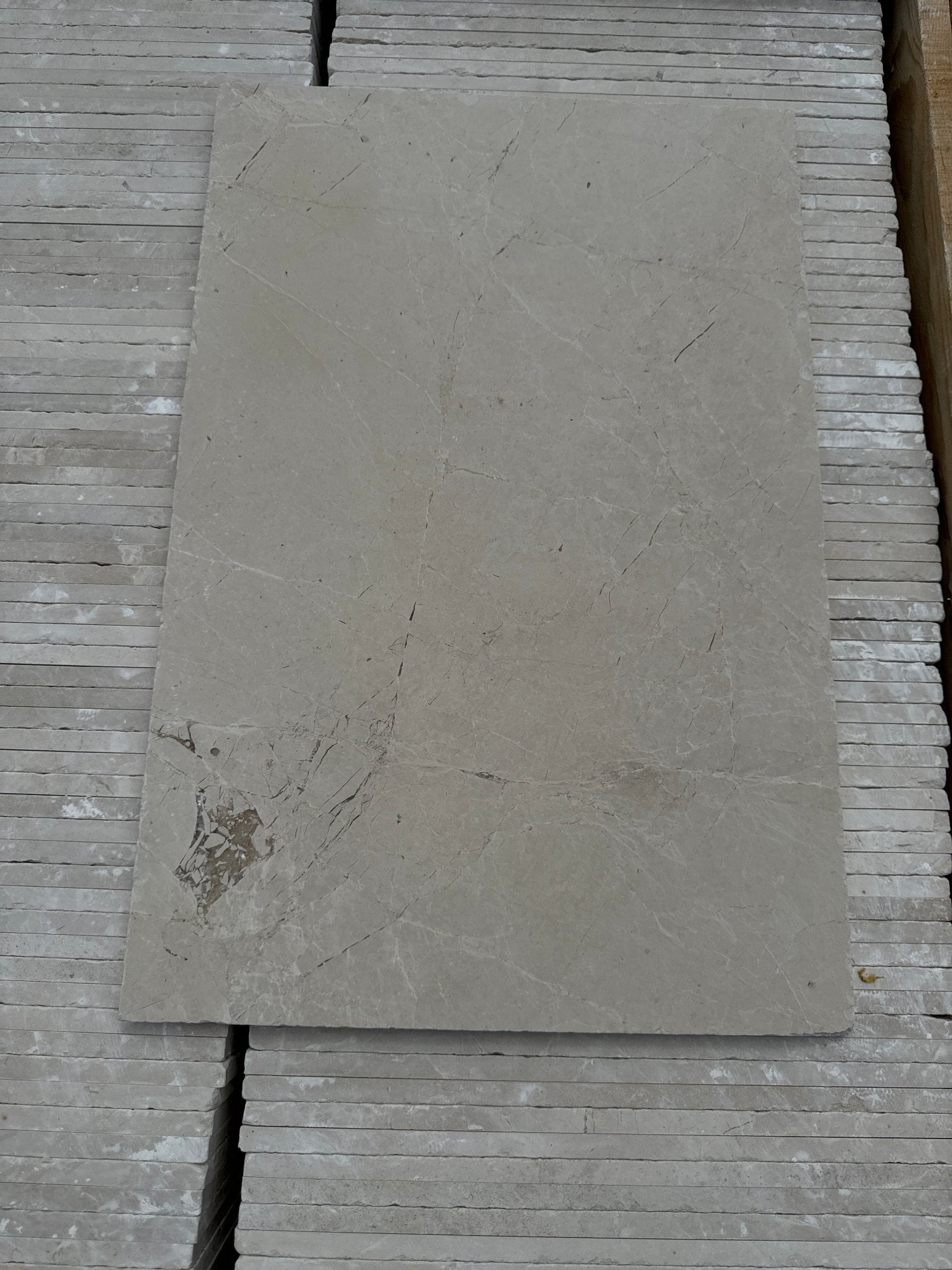 Turkish Sahara Travertine Honed and Tumbled Tiles sitting on pack of tiles