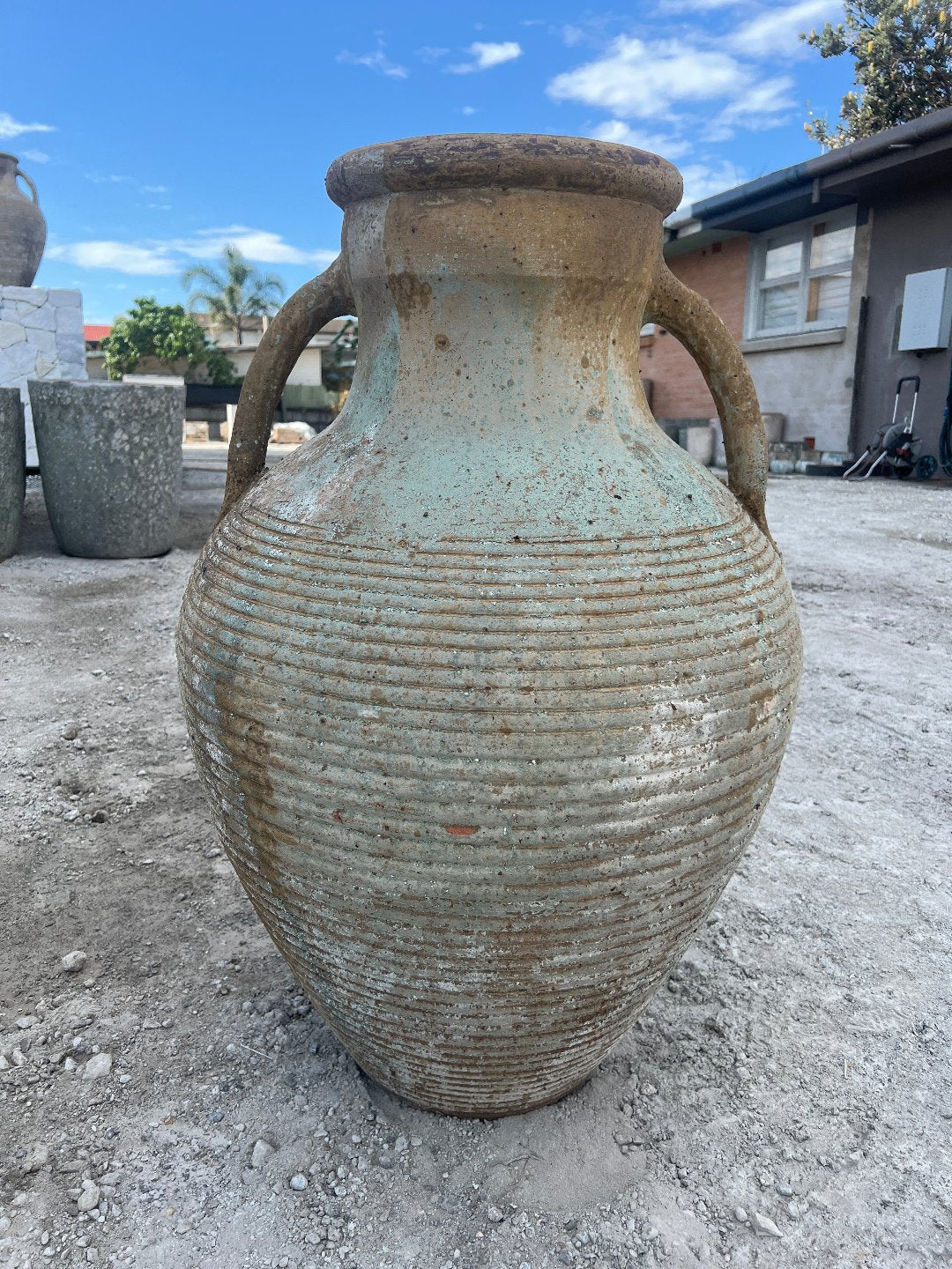 Two handle ribbed urn with warn patina outside