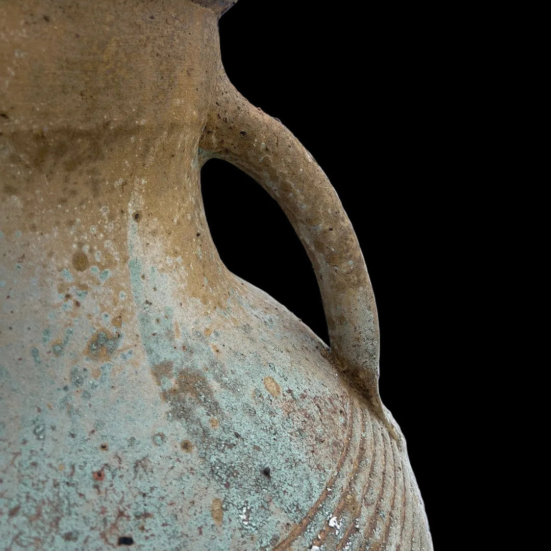 Two handle ribbed urn with warn patina outside close up of handles