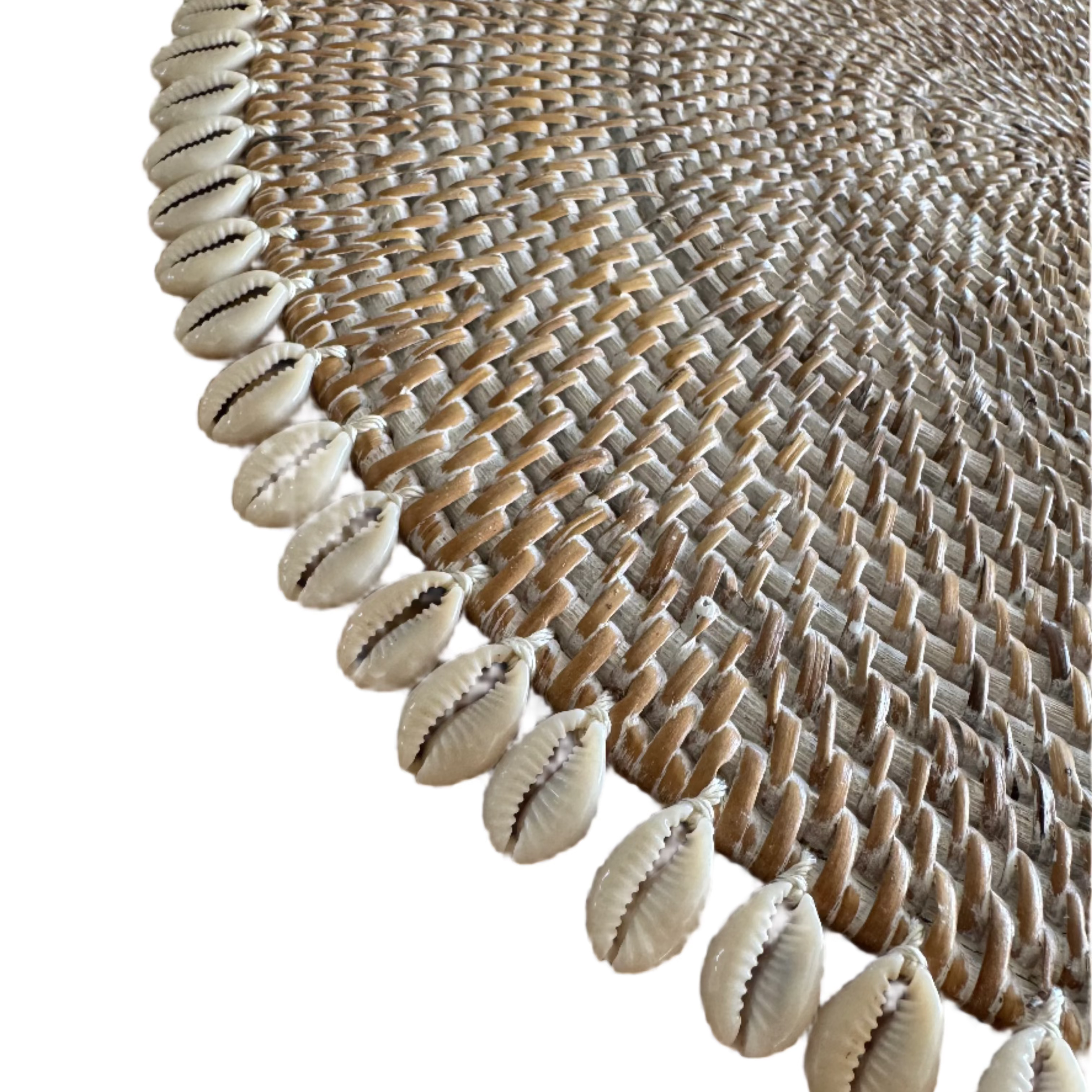 handmade round rattan placemat with cowrie shell border close up