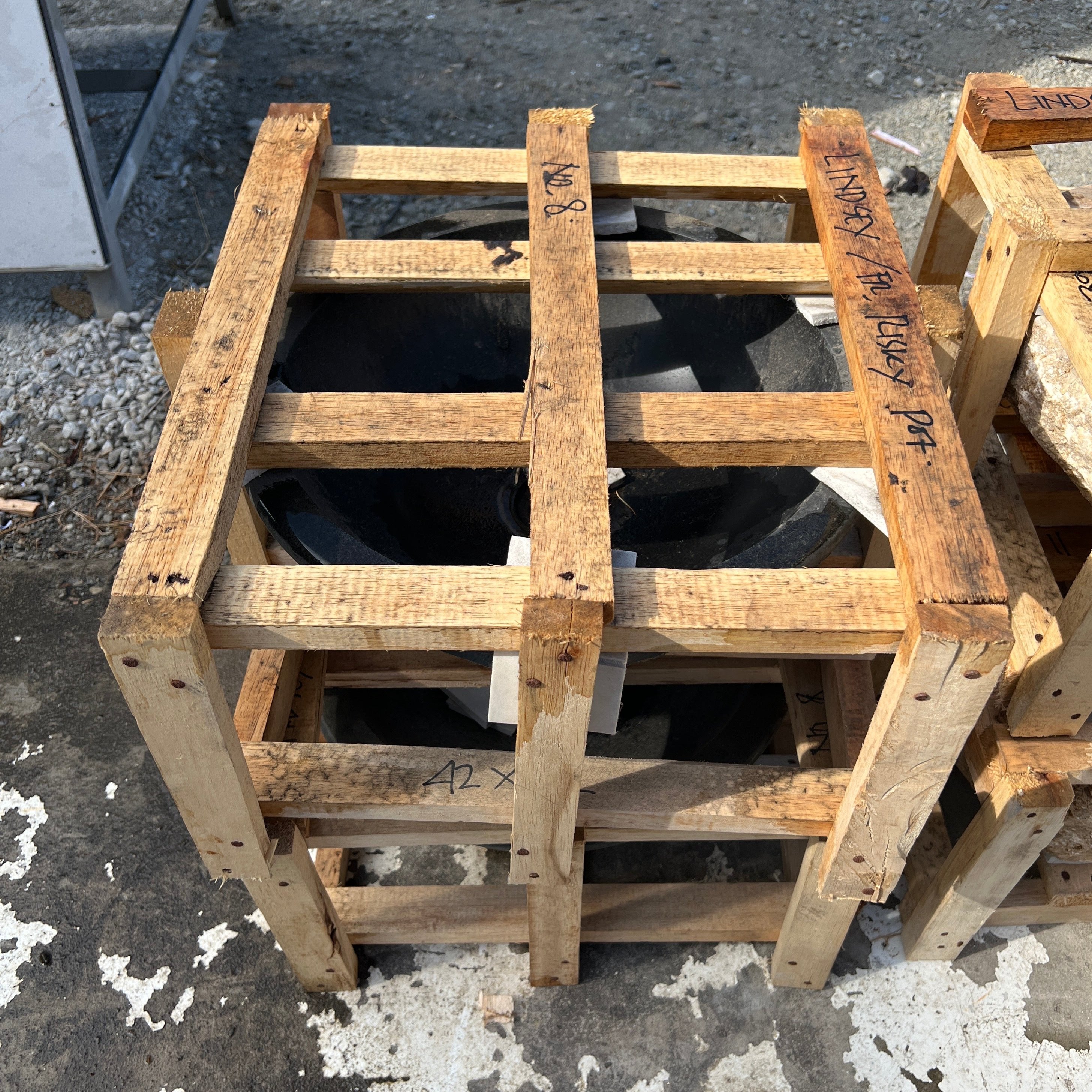 natural organic granite stone basin with star pattern underneath in a crate