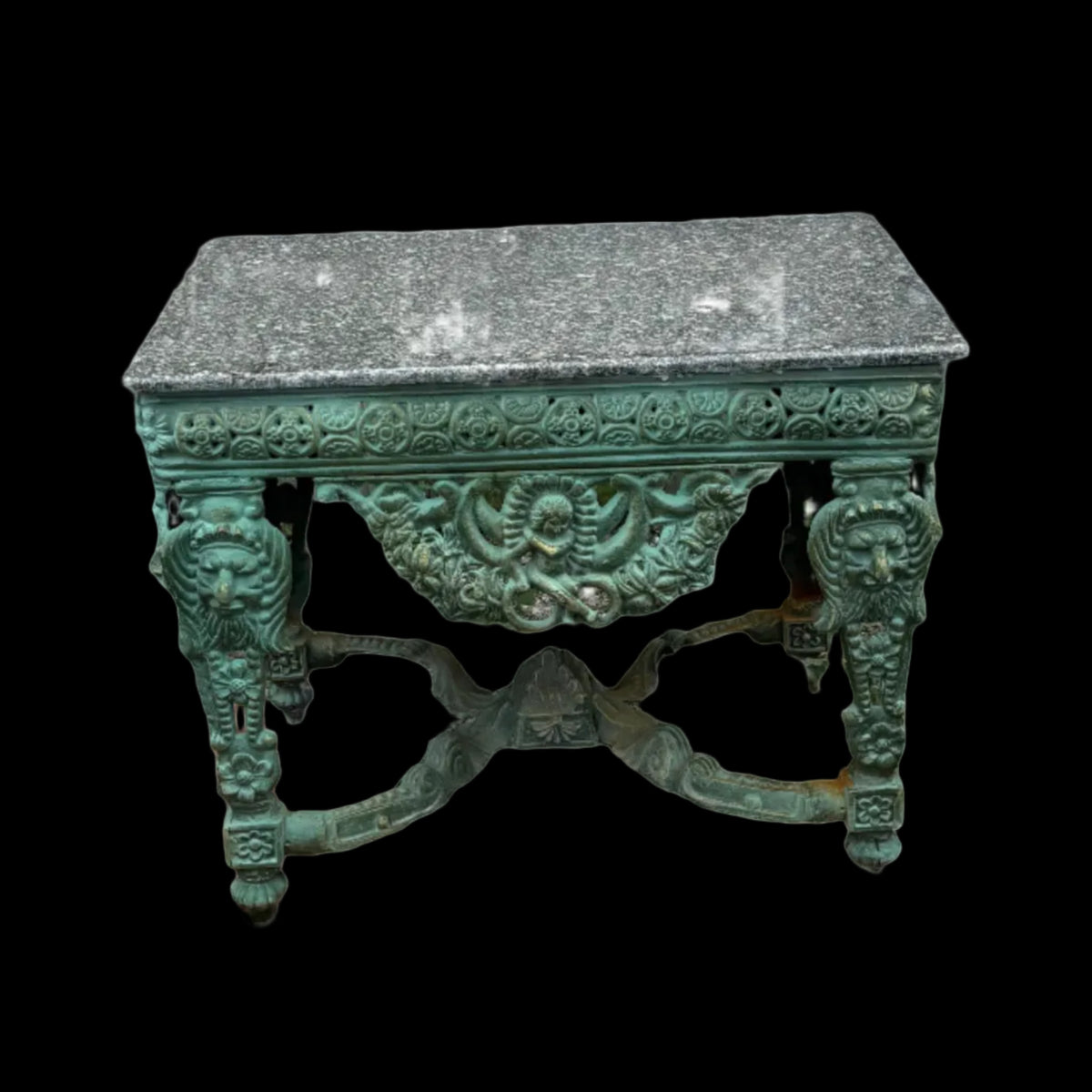 Decorative green cast iron desk with ornate design with a stone table top