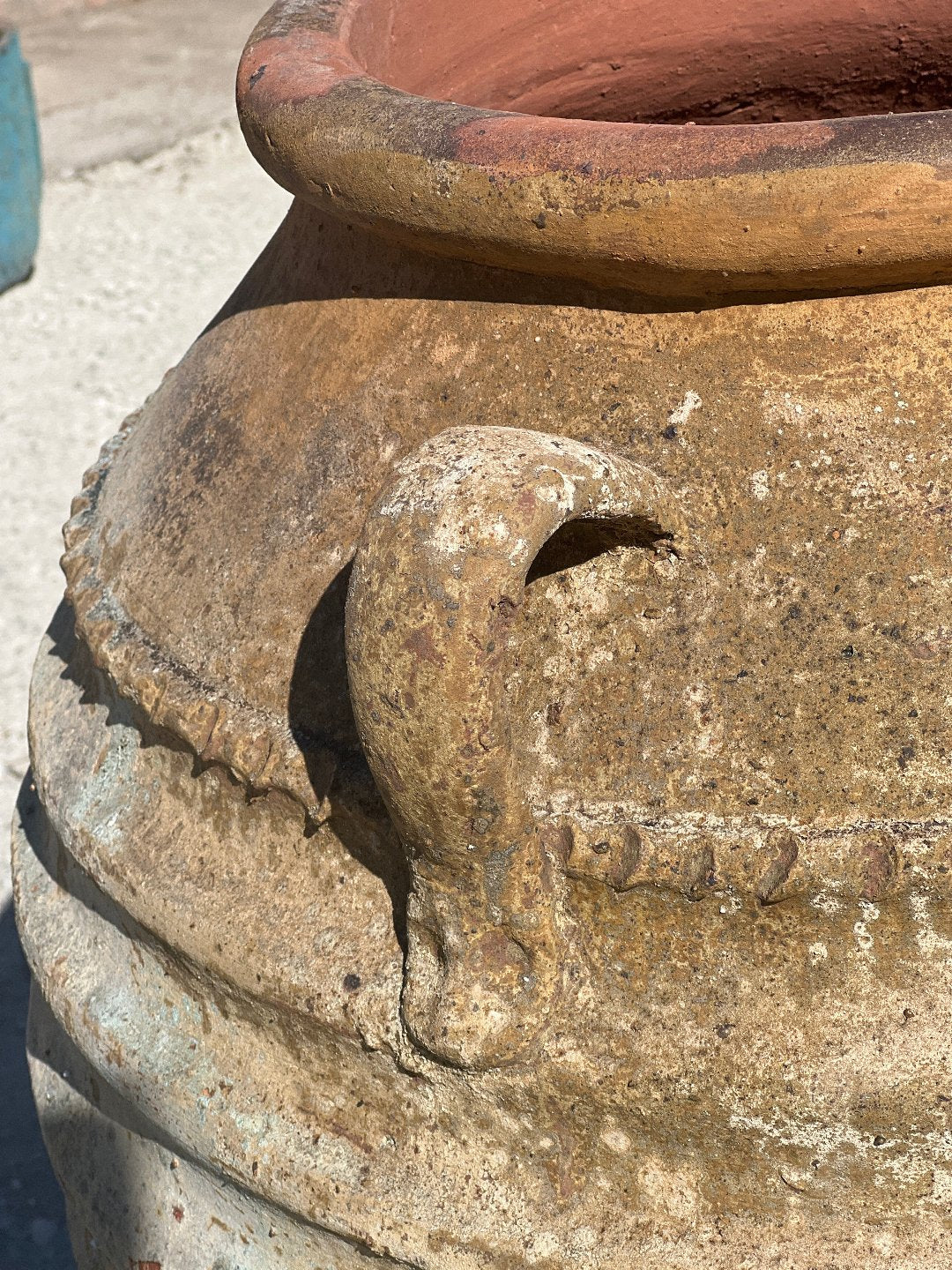 Ancient Ribbed Belly Urn with Handles and warn patina with a close up of the handles