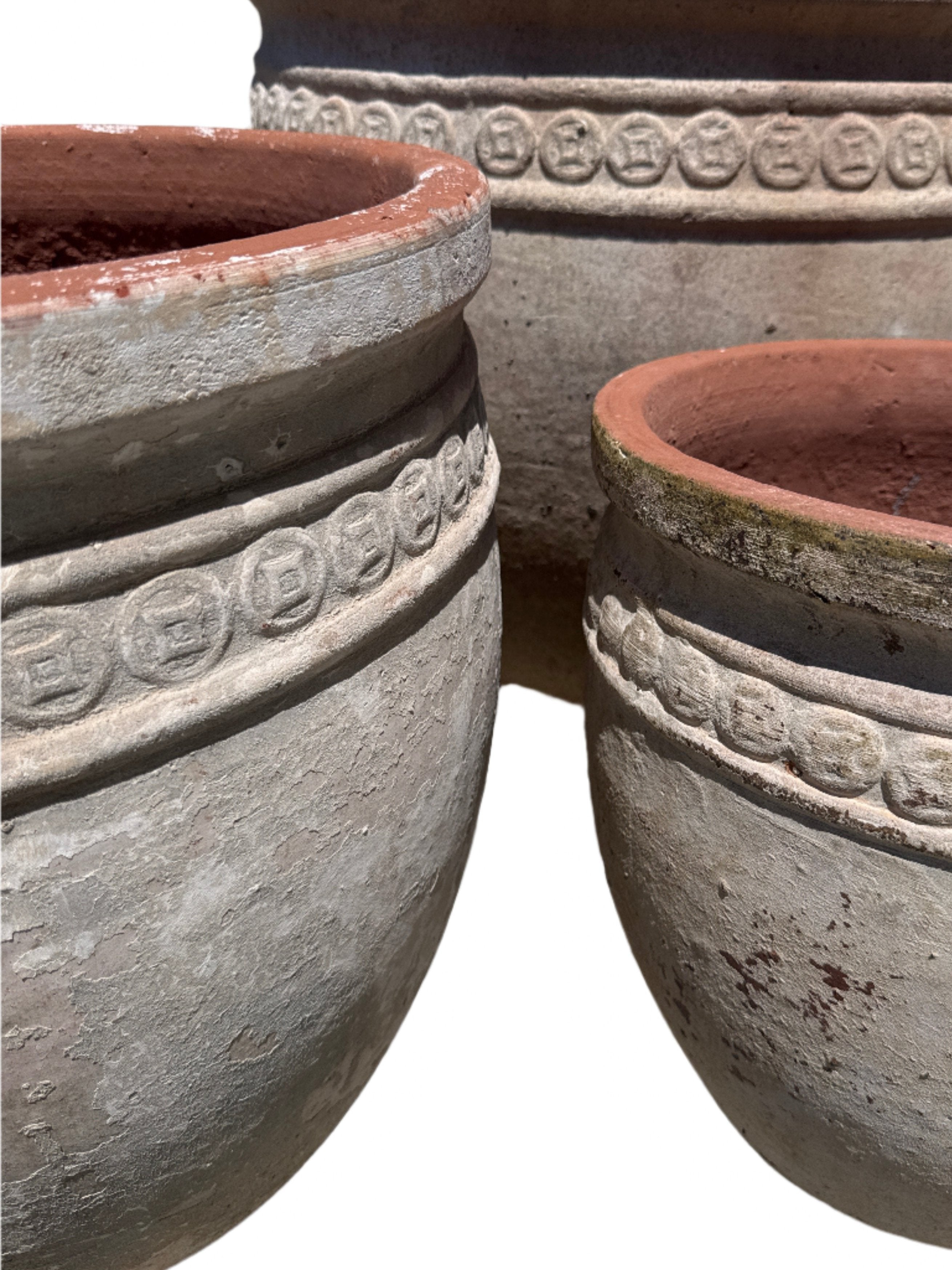 Coin Garden pots close u of coin insignia