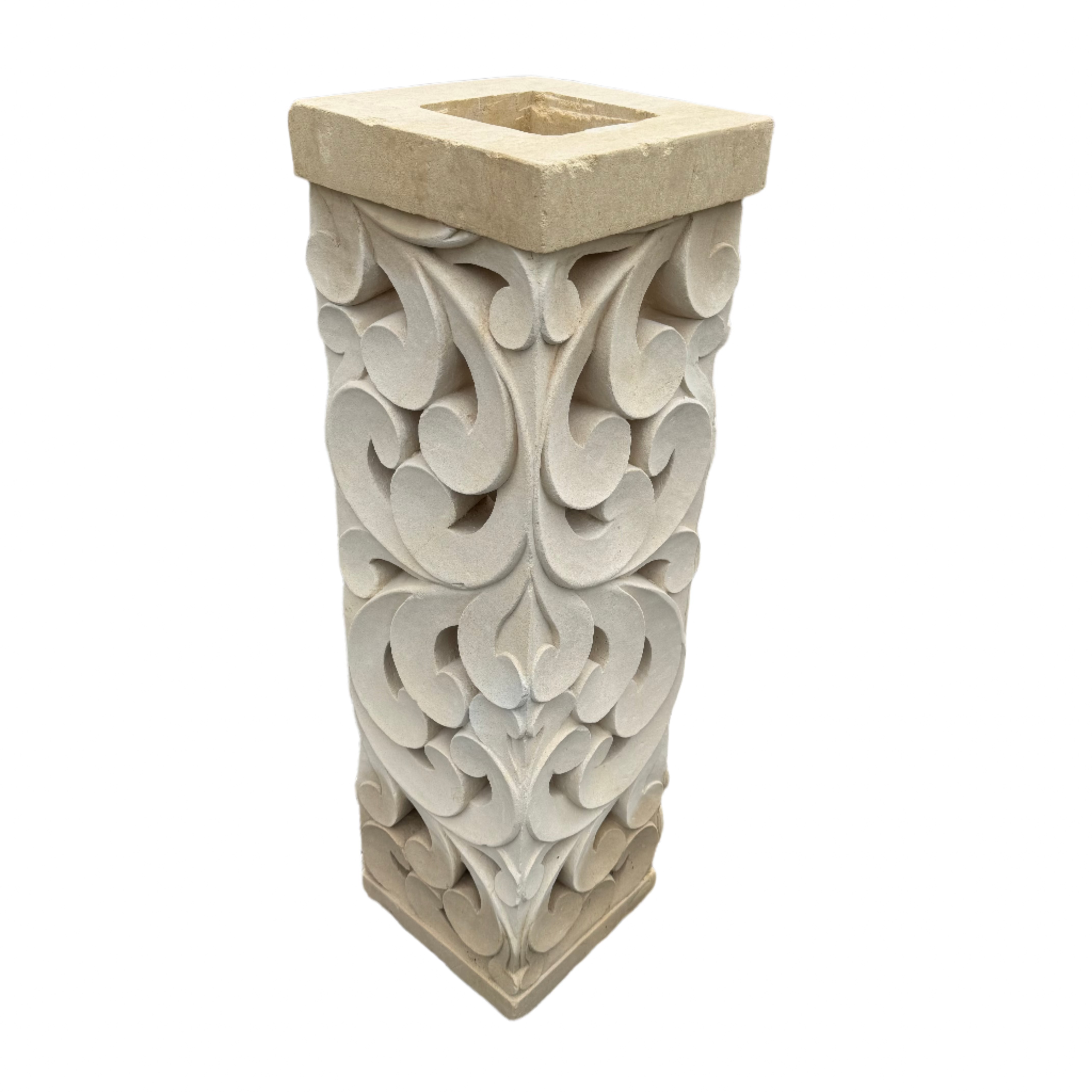 Natural organic limestone square plinth that features a hand carved ornate tribal sculpture 
