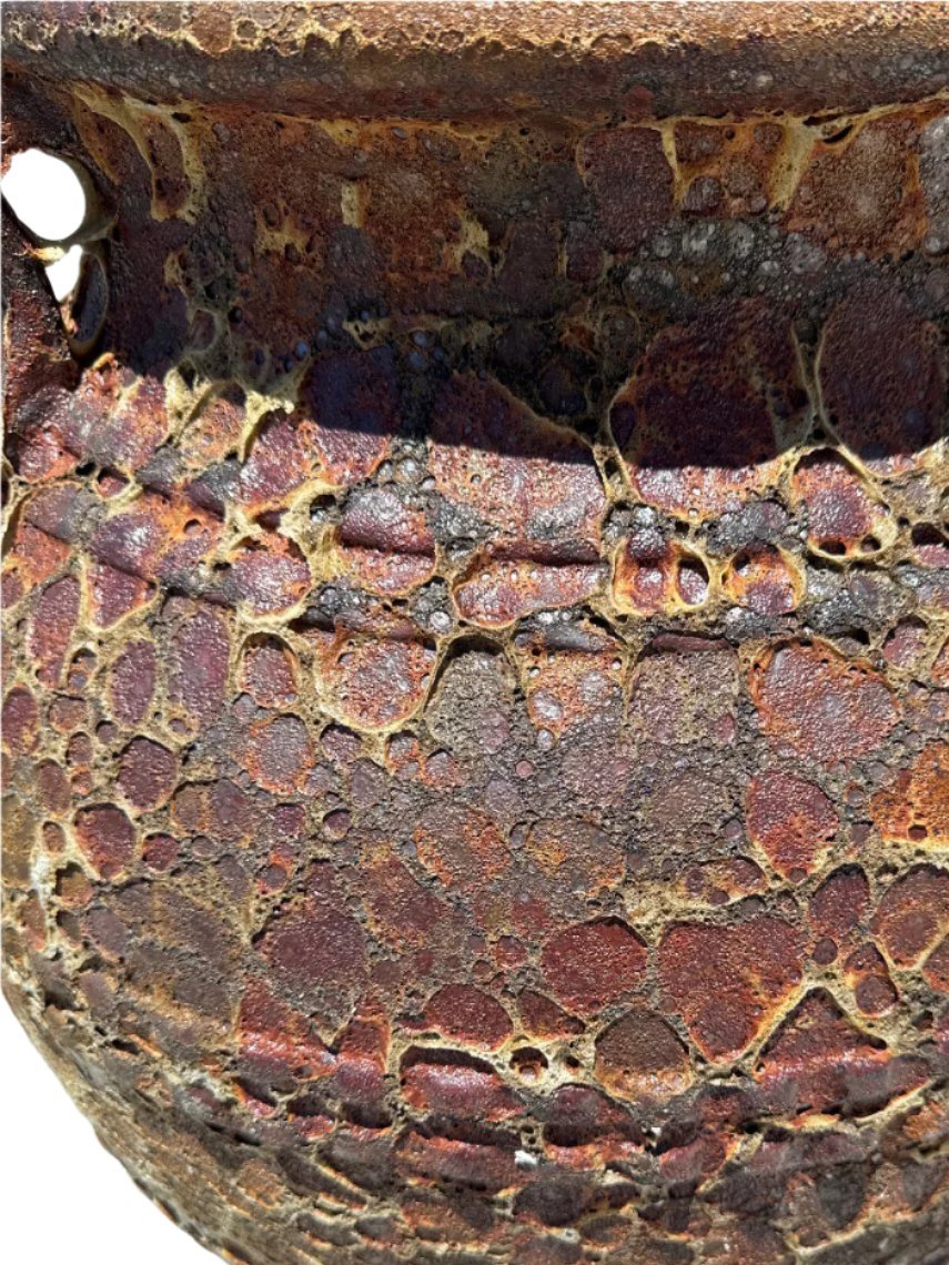 Rust lava rock Atlantis garden urn patina close up