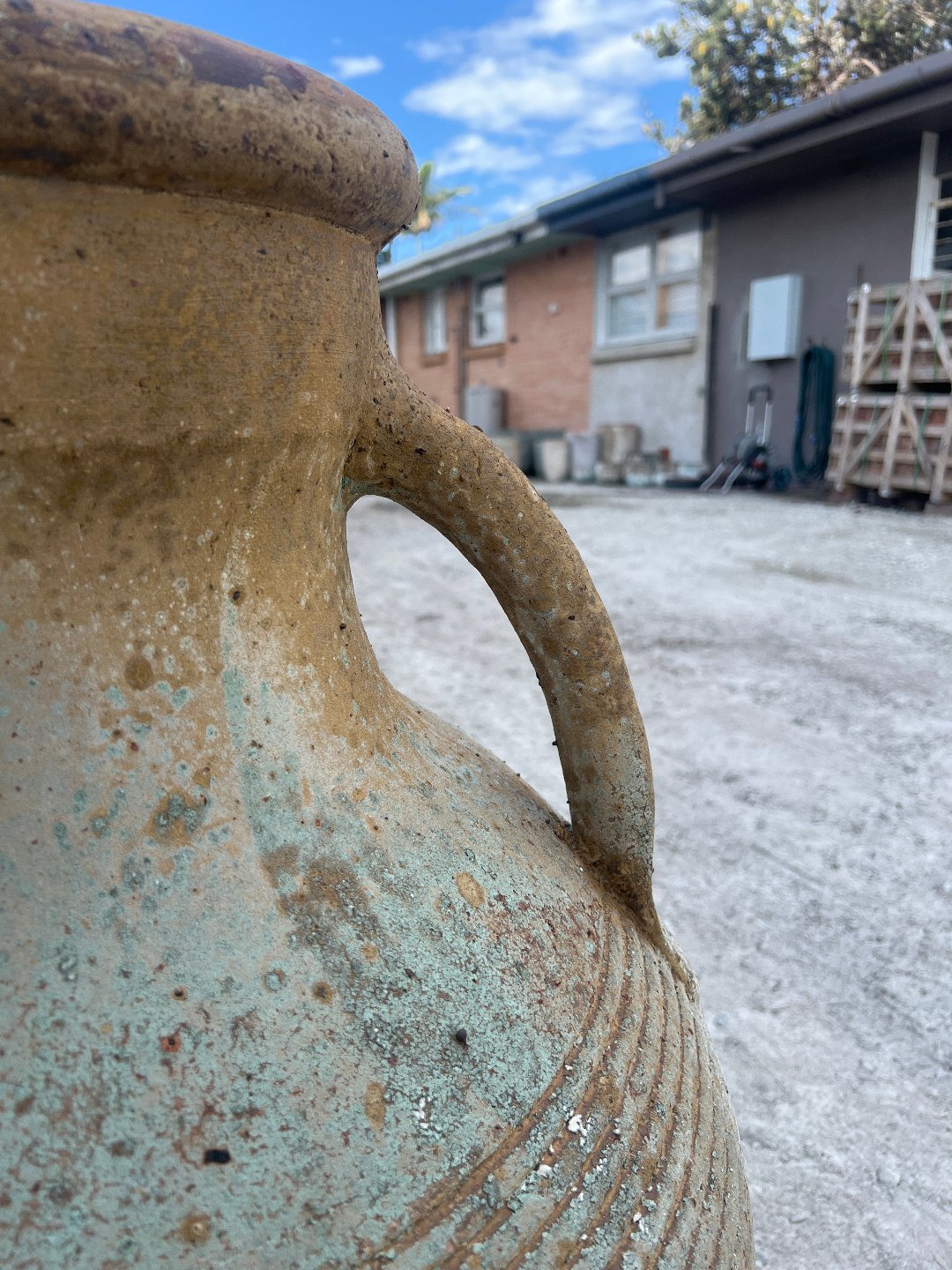 Two handle ribbed urn with warn patina outside close up of handles