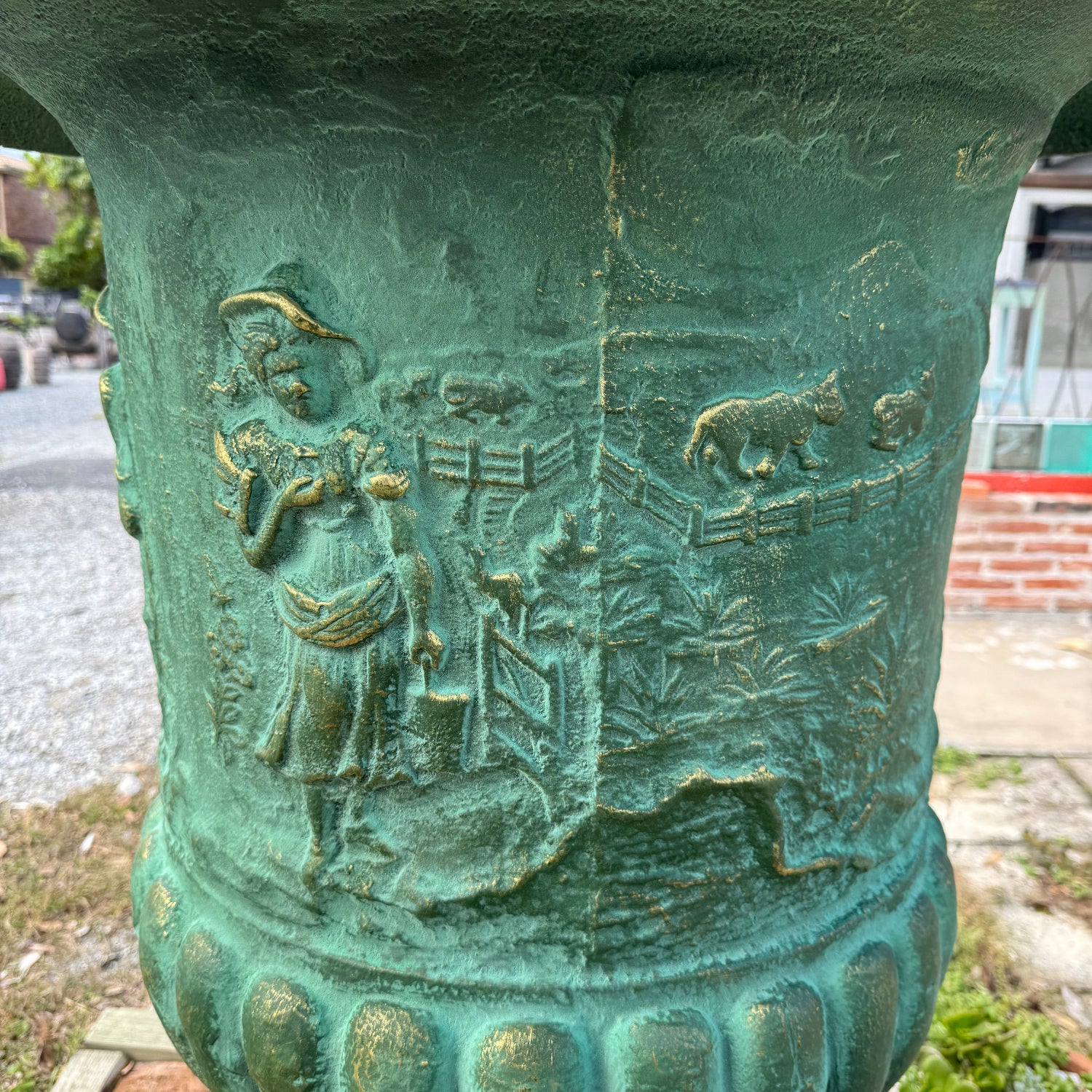close up of the extra-large cast green iron urn with illustrations