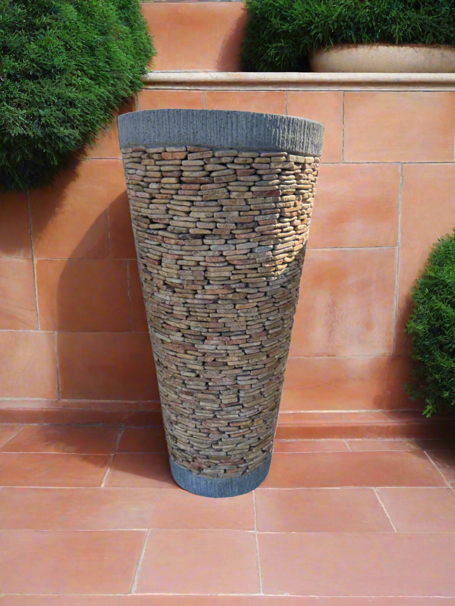 granite pebble cone garden pot pot in terracotta garden with bushes