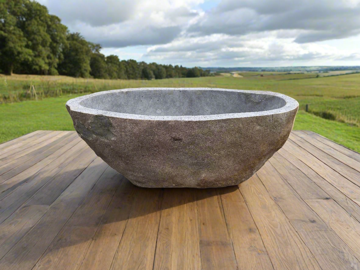 natural organic granite stone bath on wood sleeper deck outdoors