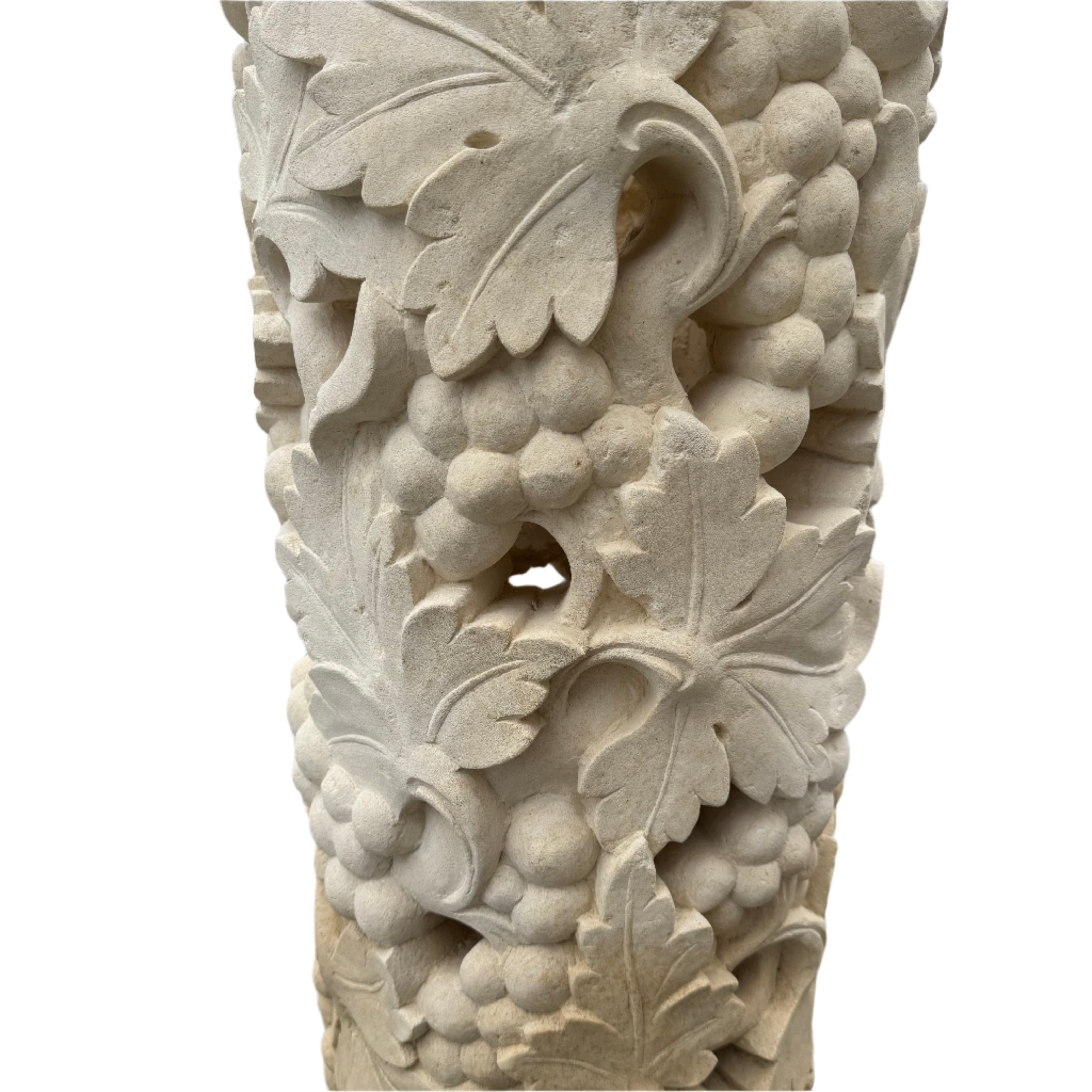 natural organic limestone pillar with ornate fruit sculpture carvings close up